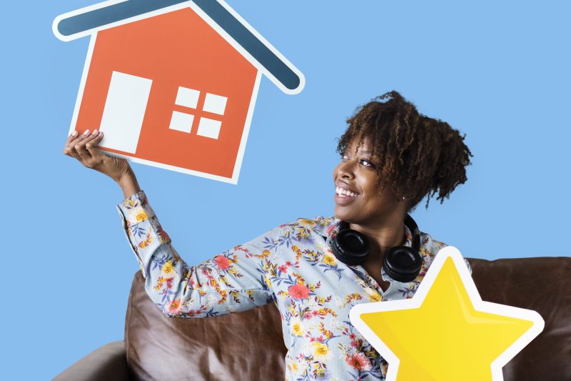 woman holding house star icons